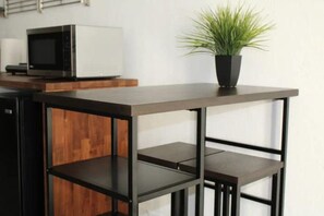 A kitchen area with a wooden countertop, a microwave, and a potted plant. - Elokut Loft 4 - Steps from Old San Juan and Escambron Beach (San Juan)