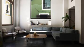 A modern living room with a sectional sofa, a coffee table, and a floor lamp.