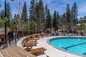 A pool area with wooden lounge chairs and a wooden deck. - 1+Den @ Monache w/ Luxury Amenities; Dog Friendly! (Mammoth Lakes)