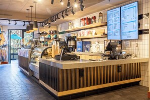 A coffee shop interior with a counter, menu boards, and a variety of coffee and food items displayed. - 1+Den @ Monache w/ Luxury Amenities; Dog Friendly! (Mammoth Lakes)