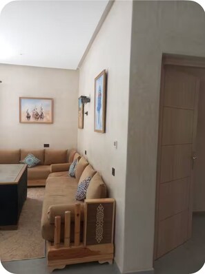 A living room with a sofa set, a coffee table, and a wooden cabinet. - New Listing (Marrakech)
