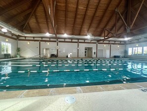 An indoor swimming pool with clear lanes, a wooden ceiling, and a clock on the wall. - The Tipsy Tarpon by Sandpiper | Near Beach (Seabrook Island)