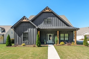 A two-story house with a front porch, a central door, and a small attached garage. - 2 Mi to LakePoint Ideal 4 Group Stays & Game Days (Emerson)
