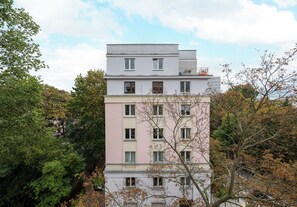 A multi-story residential building with a flat roof and a balcony on the upper floor. - Metro Politechnika Central Apartment (Warszawa)