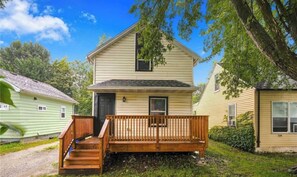 A two-story house with a front porch and a small front yard. - Peaceful 3 bedroom house close 2 interstate access & restaurants 14 mins to data (Cedar Rapids)