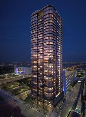A high-rise building with multiple floors, large windows, and a modern architectural design. - Luxury Miami 1BR + Den | Sleeps 5 (Miami)