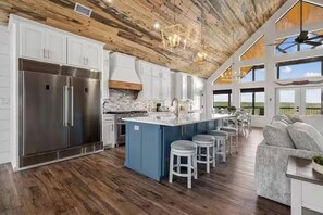 A spacious kitchen with a large island, stainless steel appliances, and a view of the outdoors. - Panoramic views, Creek, Total Privacy, 1 of a Kind (Broken Bow)