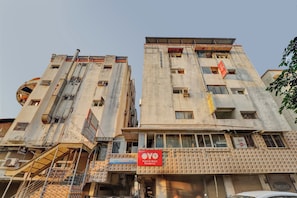 A multi-story hotel with a sign for 'Hotel Sri Balaji Residency' and a visible staircase leading to an upper floor. - Hotel O Rudra Palace (Ahmedabad)