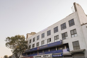 A multi-story building with several commercial establishments, including banks and a trade link. - Hotel O Madhav Villa (Ahmedabad)