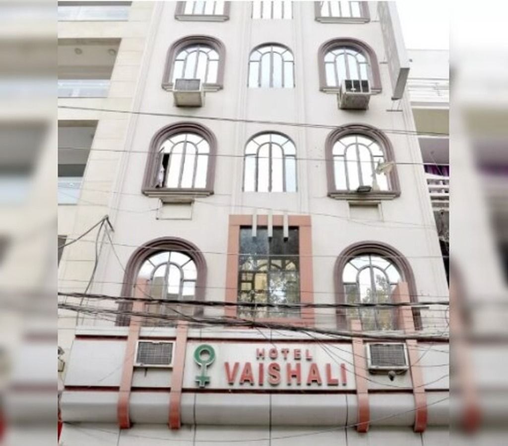 A building with a sign reading 'HOTEL VAISHALI' and multiple windows.