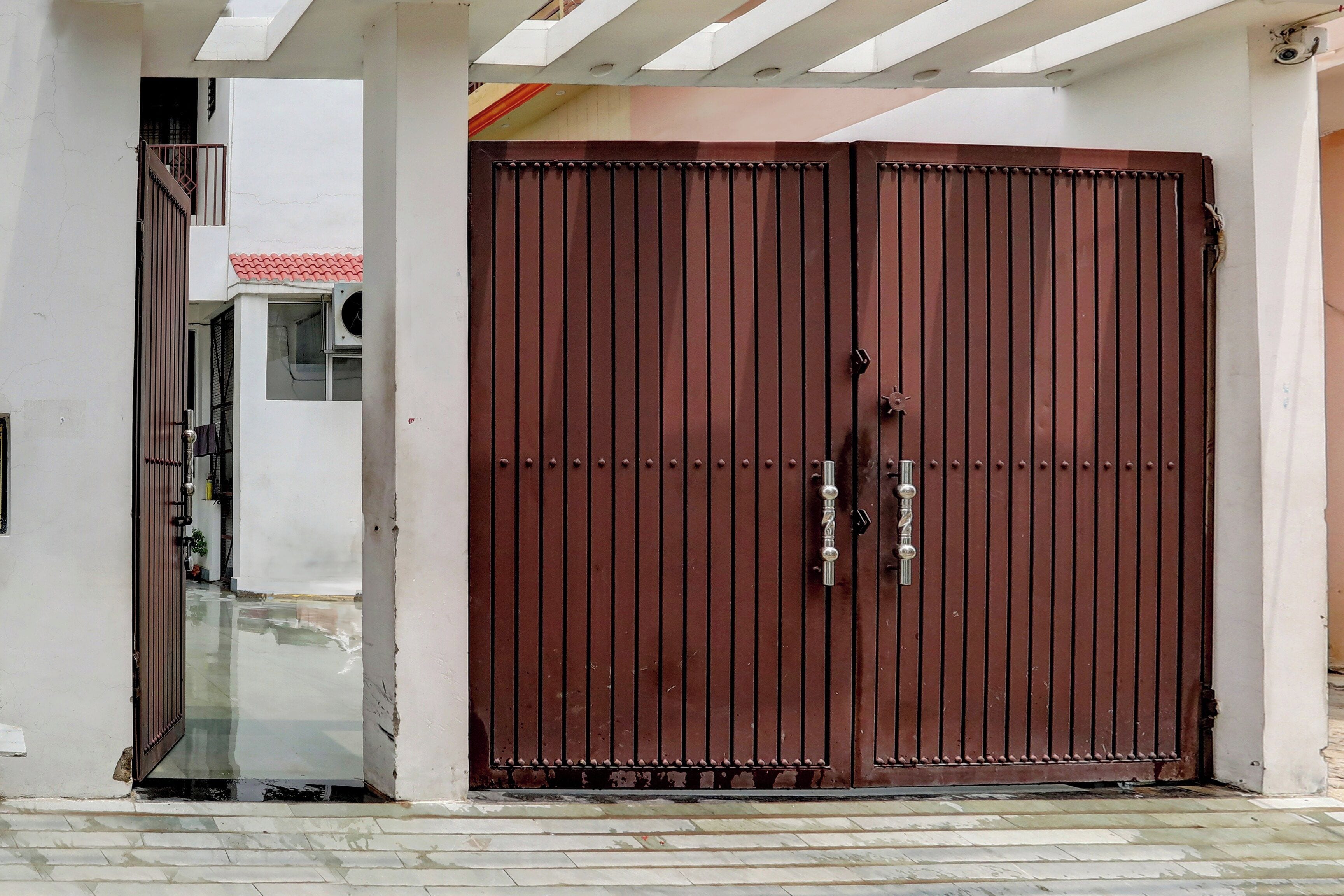 A large, closed metal gate with a central handle and a keyhole.