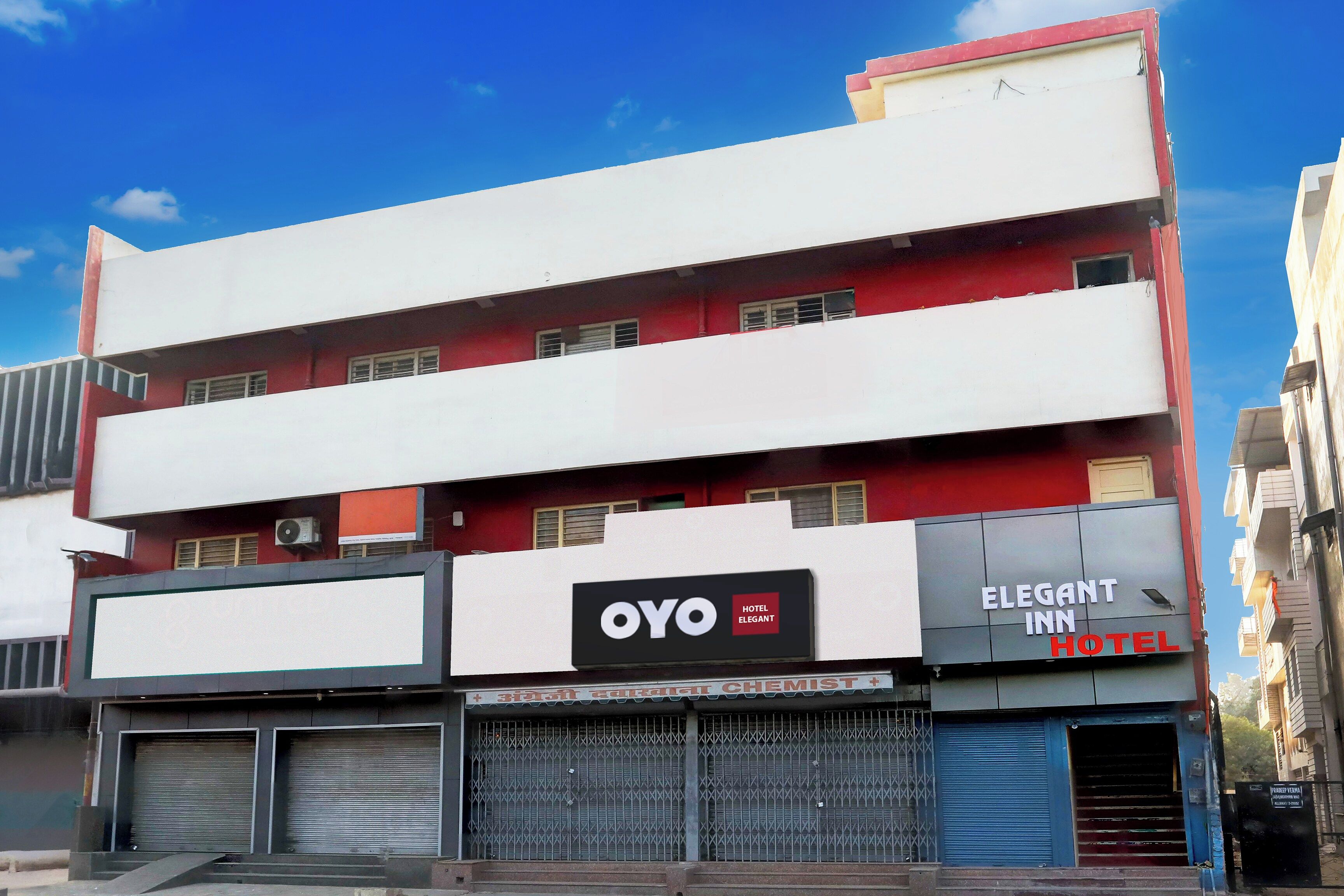 A multi-story building with a hotel named 'OYO Hotel Elegant' on the ground floor.