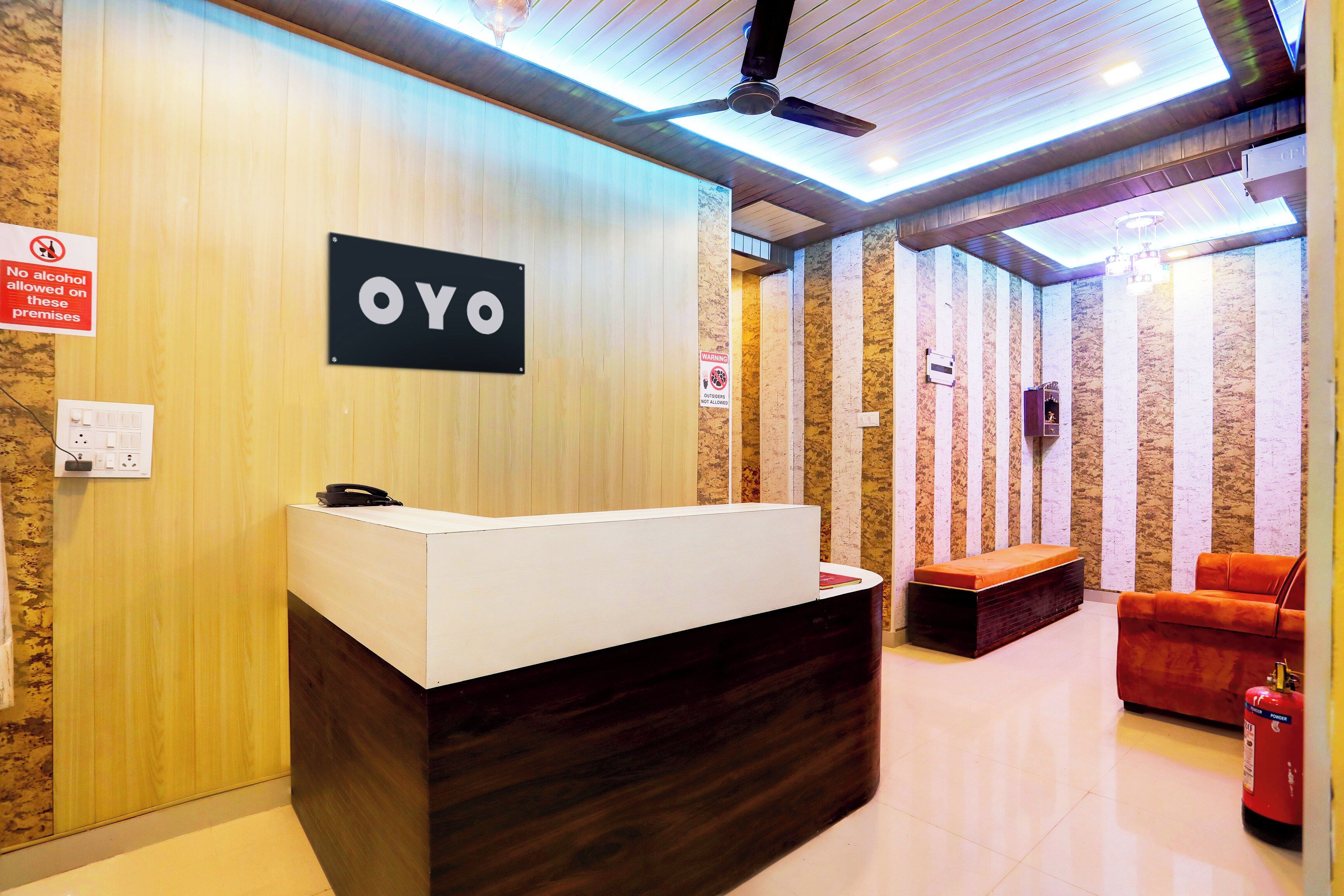 A reception desk with a sign that reads 'OYO' and a no alcohol allowed sign.