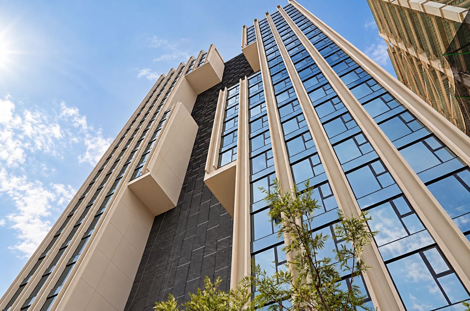 A high-rise building with a modern architectural design, featuring a prominent facade with large windows and a geometric pattern.