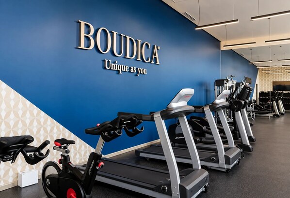 A gym with treadmills, stationary bikes, and a wall with the text 'BOUDICA Unique as you'. - APT21 Puebla - Volcano, Ferris Wheel & City Views in Torres Boudica (San Andrés Cholula,)