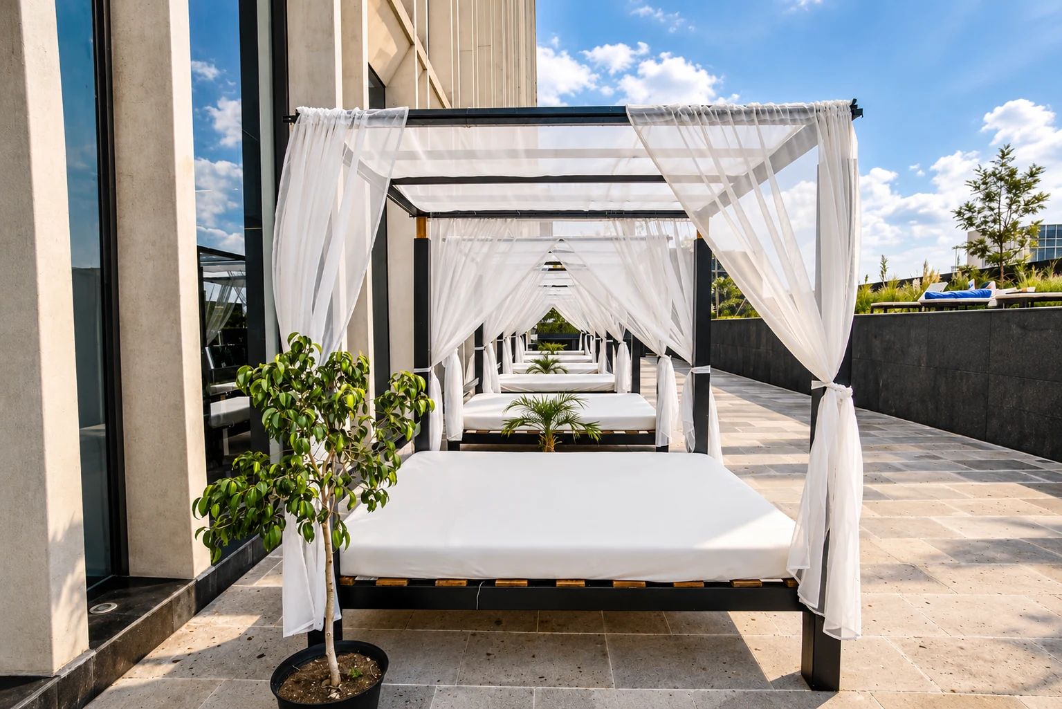 A private outdoor seating area with a canopy, a single bed, and a potted plant.