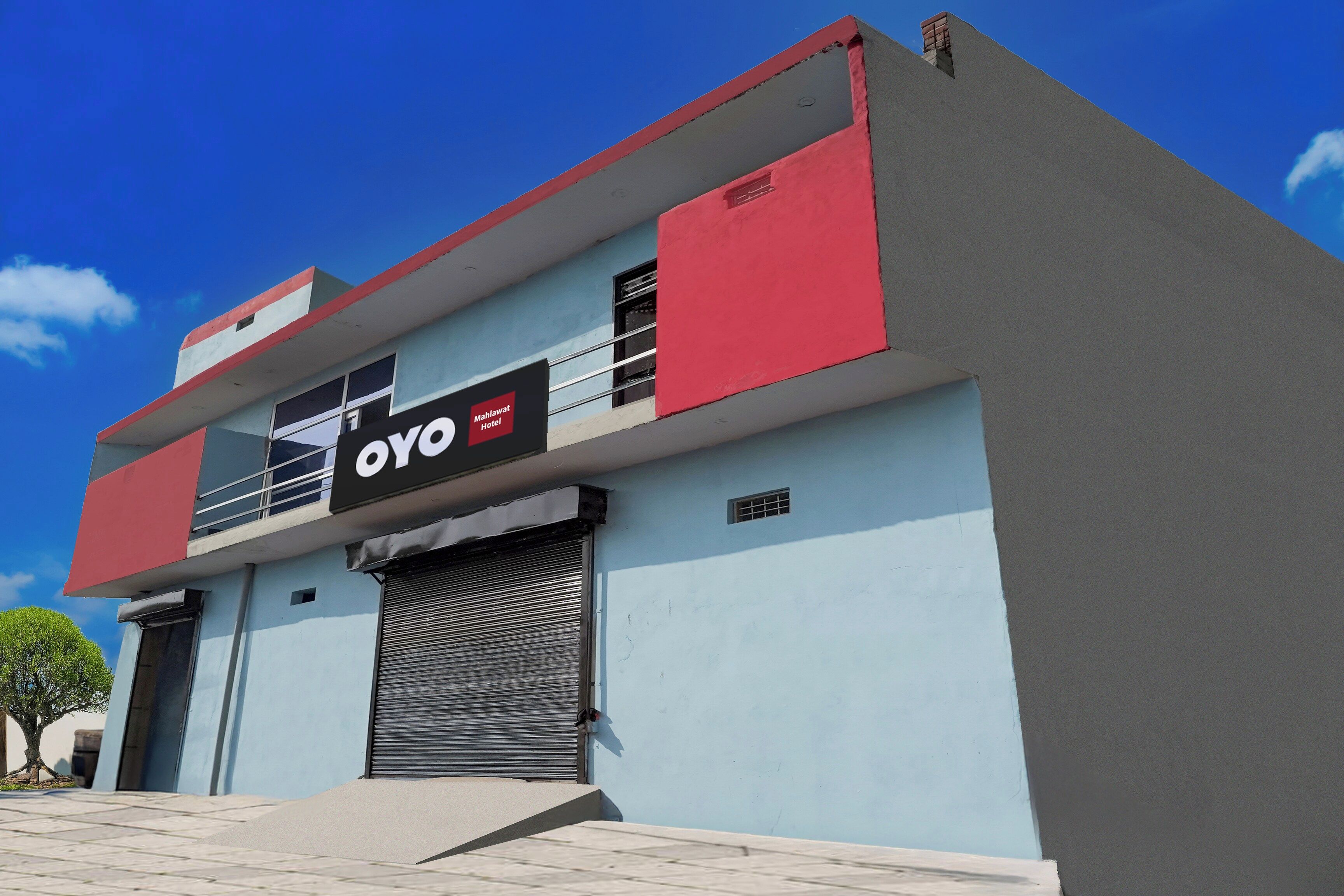 Un edificio moderno con un cartello che indica 'OYO Hotel' sulla facciata.
