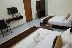 A hotel room with two beds, a TV, a desk, and a chair. - The Golden Park (Dindigul)
