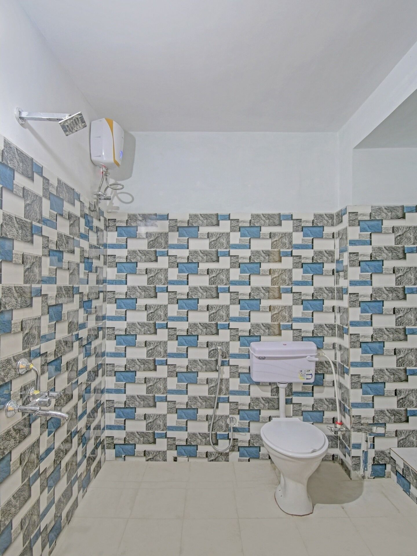 A bathroom with a tiled wall, a toilet, and a shower.