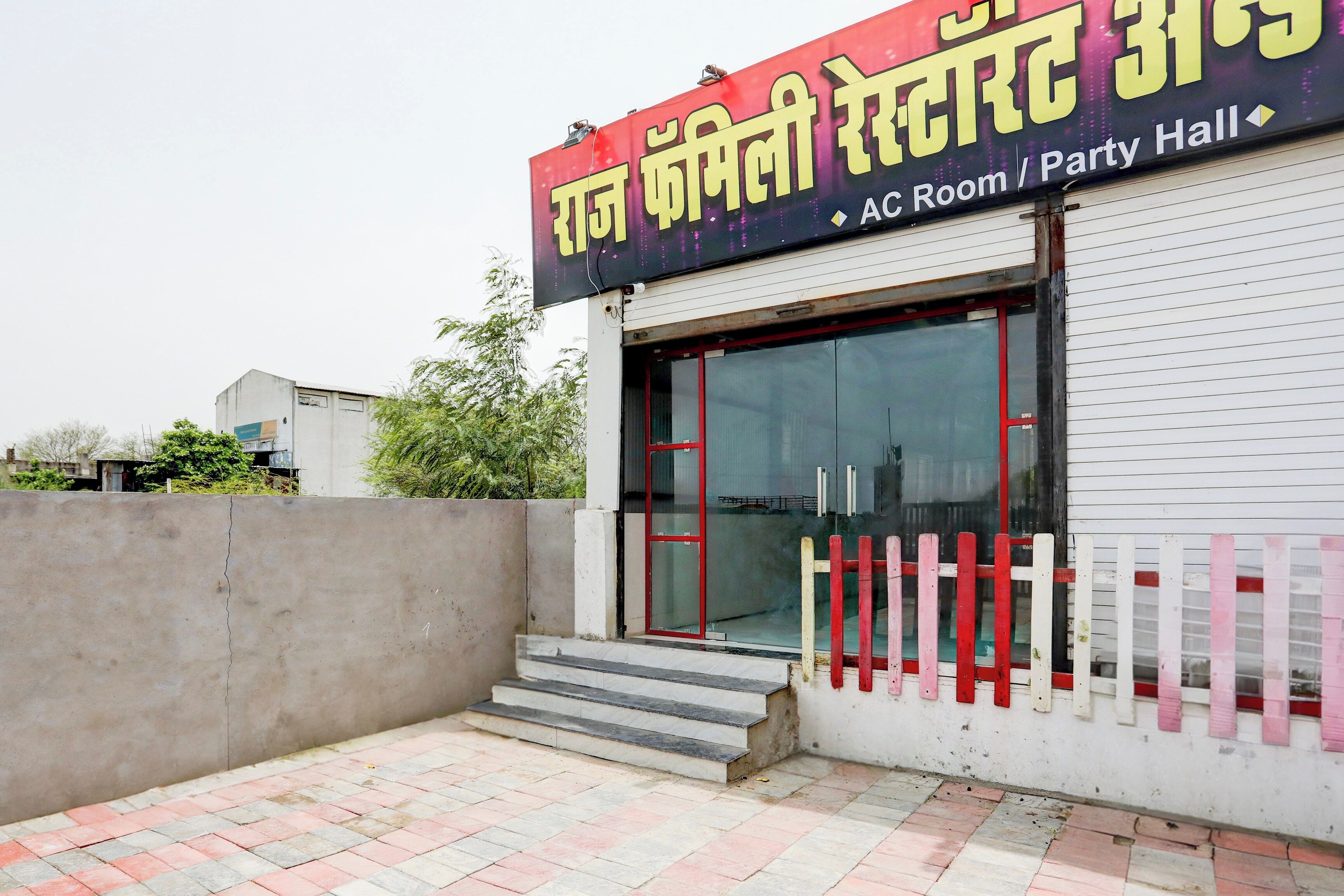 A building with a sign indicating it is an AC Room/Party Hall.