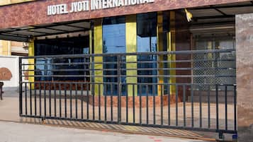 A hotel entrance with a metal gate and a sign that reads 'HOTEL JYOTI INTERNATIONAL'.