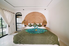 A bedroom with a large bed, a window with curtains, and a view of greenery outside. - ASHITA by SEAOM Villas (Gianyar)