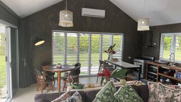 A modern interior with a dining area, kitchen, and seating space.