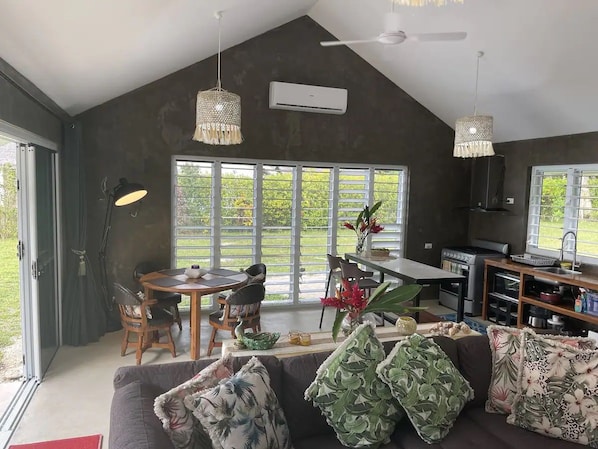 A modern interior with a dining area, kitchen, and seating space.