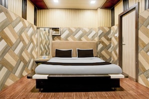 A hotel room with a bed, bedside table, and a mirror on the wall. - Hotel O Avista Comfort (Amritsar)