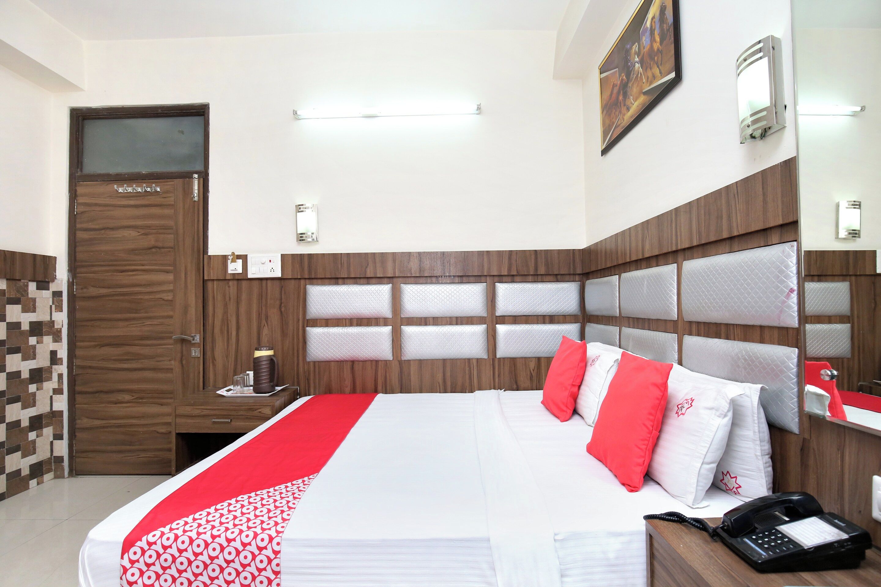 A hotel room with a bed, bedside table, and a telephone.