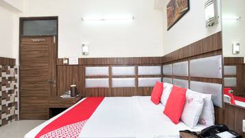 A hotel room with a bed, bedside table, and a telephone.