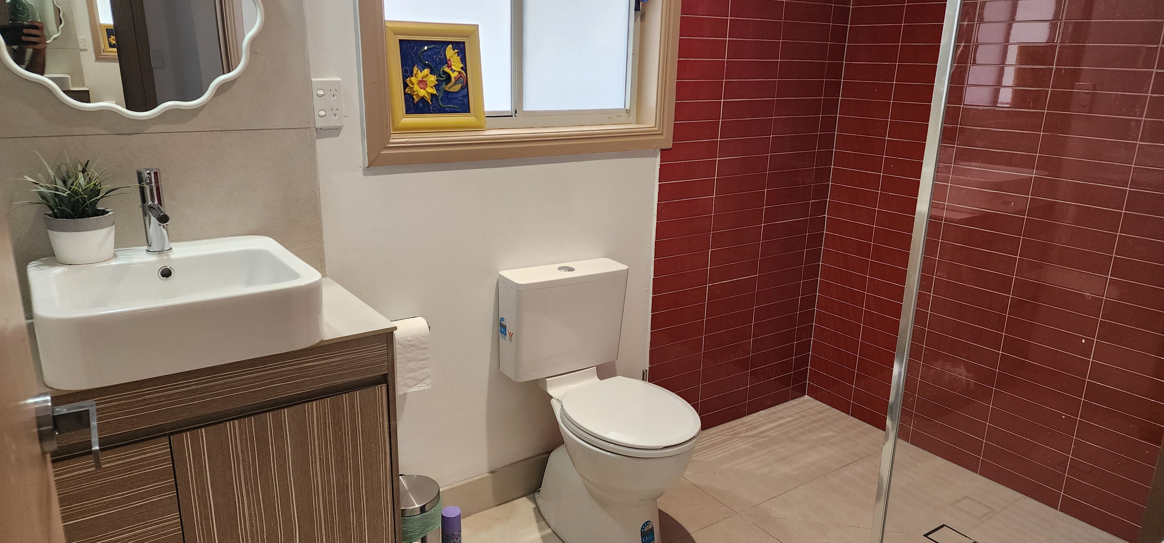 A bathroom with a sink, toilet, and shower.