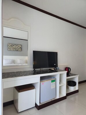A kitchenette with a microwave, refrigerator, and a coffee maker on a white countertop. - Issara Patong Beach (Patong)