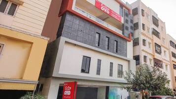 A multi-story building with a prominent red and white sign indicating 'Flagship Elite Spaces.'