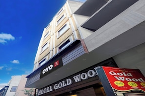 A hotel named 'Hotel Gold Wood' with a sign indicating amenities like free Wi-Fi, parking, and room availability. - Hotel O Gold Wood (Amritsar)