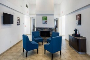 A reception area with a flat-screen TV, a fireplace, and a coffee machine. - 1 King Bed | Smoking, Micfridge (Irving TX)