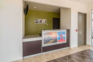 A reception desk with a sign for extended stay. - 2 Queen Beds|NS| Kitchen (New Braunfels)