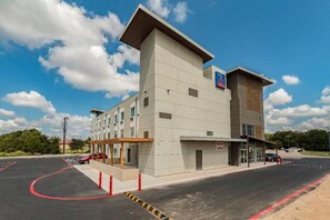 A hotel with a modern design, featuring a flat roof and a sign indicating it is now open. - 2 Queen Beds|NS| Kitchen (New Braunfels)
