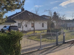 A residential house with a tiled roof, a paved driveway, and a metal fence. - Holiday Home With 5 Bedrooms (Ueckermuende)
