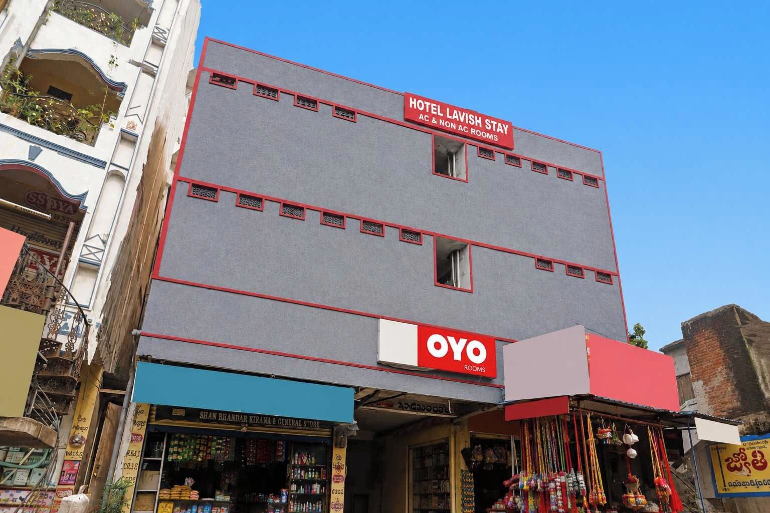A hotel with a sign for 'Hotel Lavish Stay' and 'Oyo Rooms' on the facade.