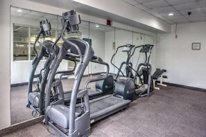A gym with treadmills, elliptical machines, and a mirrored wall. - 1 King Bed | Non-Smoking, Kitchen (Dallas)