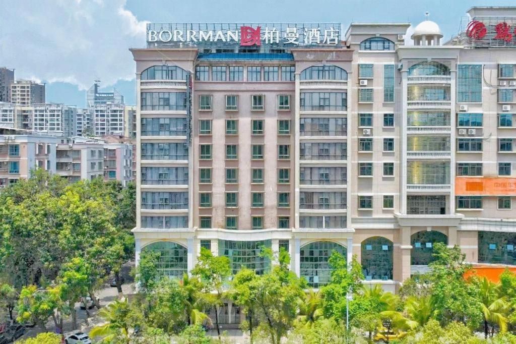 A multi-story hotel with a modern facade, large windows, and a prominent signage.