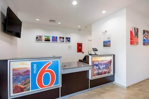 A hotel reception area with a large sign reading '6 motel' and a quote poster on the wall. - 1 King Bed | Non-Smoking, Micfridge (Channelview)
