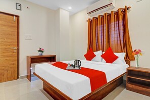 A hotel room with a bed, a nightstand, a vase with flowers, and an air conditioning unit. - Hotel O by OYO Night Eye (Hyderabad)