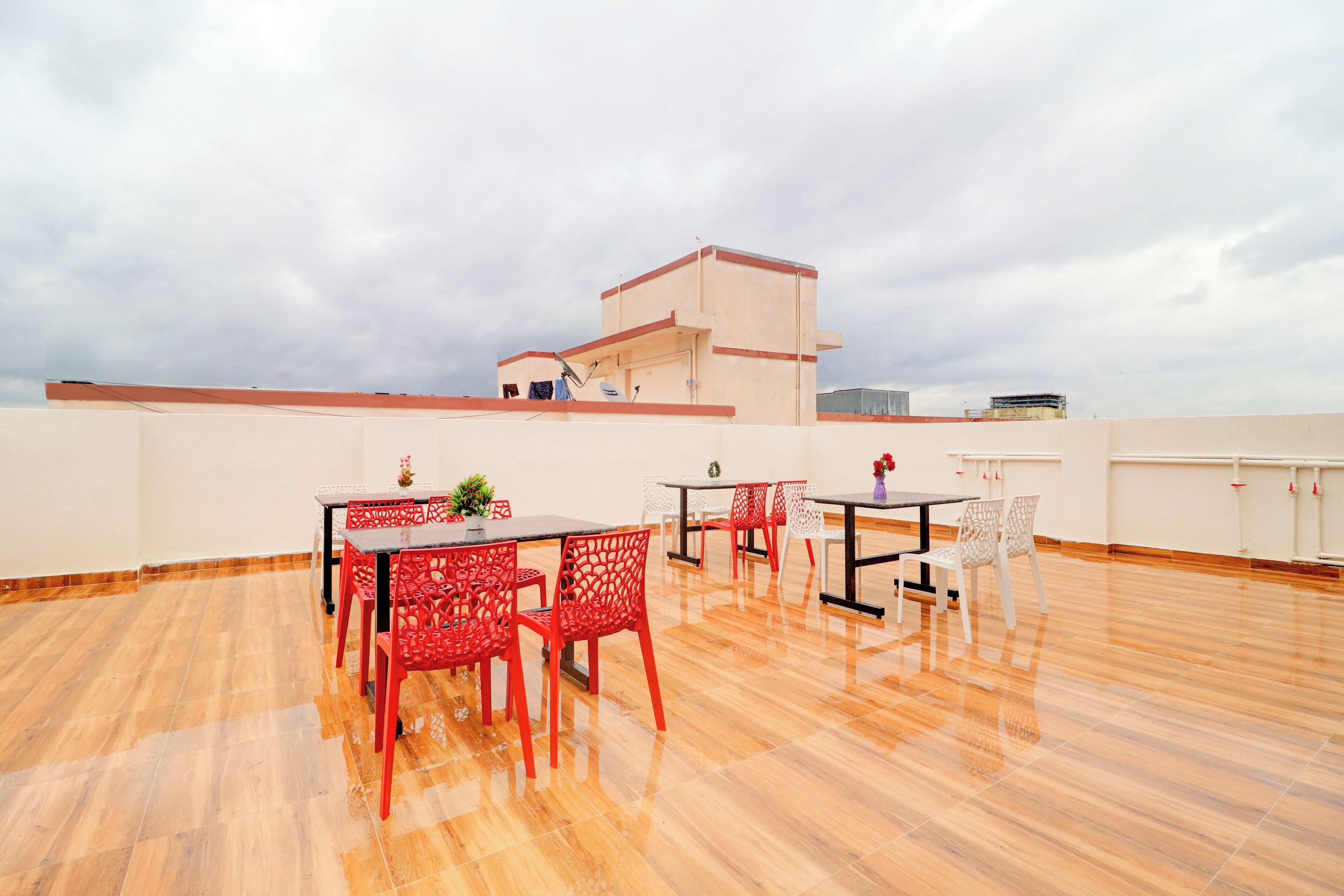 A rooftop terrace with outdoor seating and a view of the city skyline.