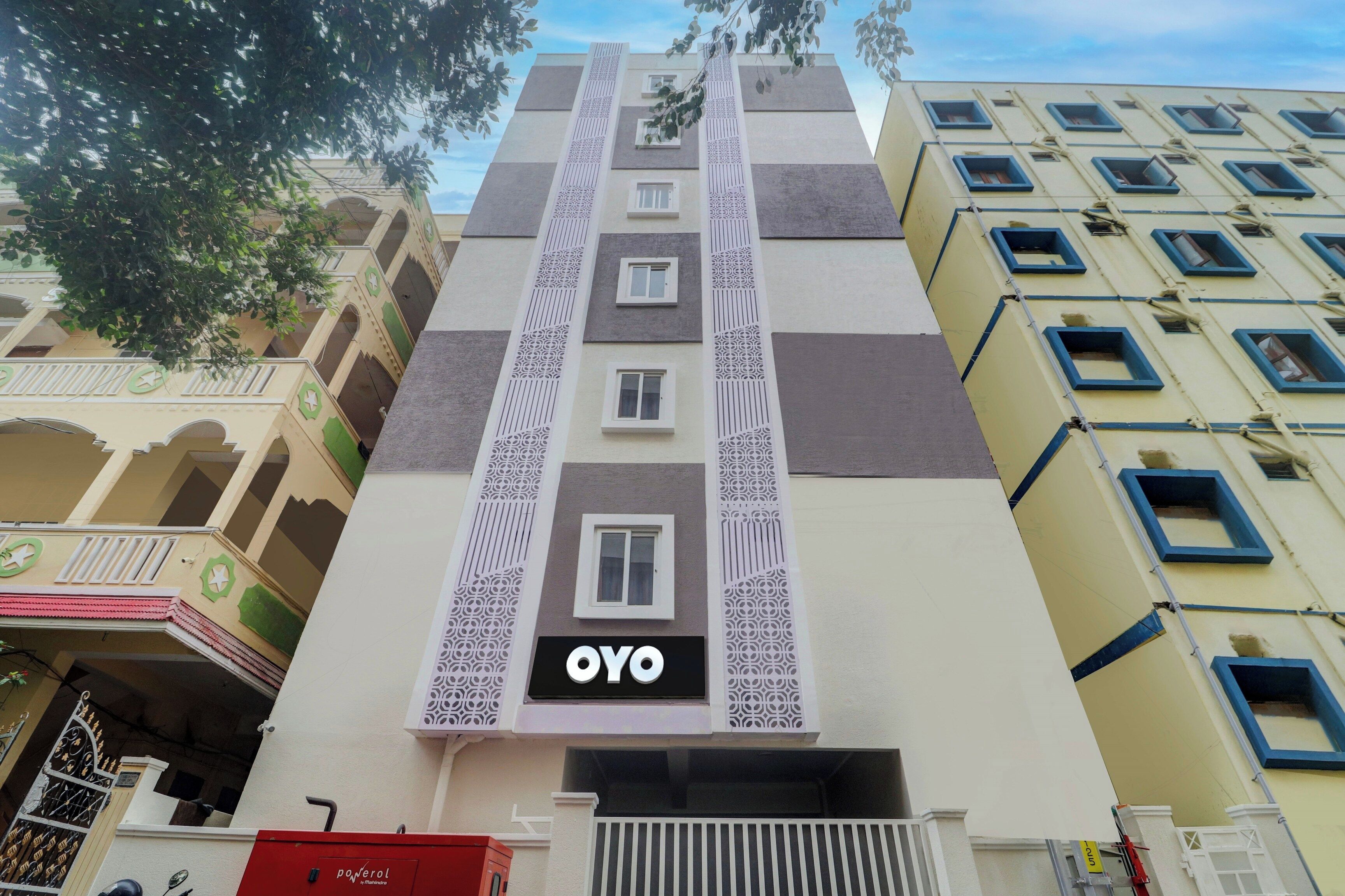 A multi-story building with a prominent sign reading 'OYO' on the facade.