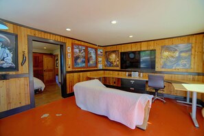 A room with a bed, a desk, a chair, and artwork on the walls. - Spacious Beautiful Country Home on 8 Private Acres (Kelseyville)