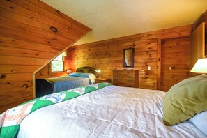 A bedroom with two beds, wooden walls, a dresser, and a window. - Caspian Lakefront Home w/ Dock and Private Beach (Greensboro)