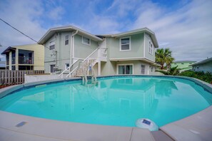 A two-story house with a swimming pool, a staircase, and a fenced yard. - Walk to the Beach! Bright Cape Canaveral Apt (Cape Canaveral)