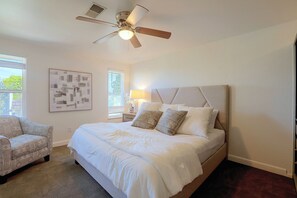 A bedroom with a bed, a chair, a ceiling fan, and a window. - Cherry Creek Reservoir Trail Access On-Site! (Englewood)
